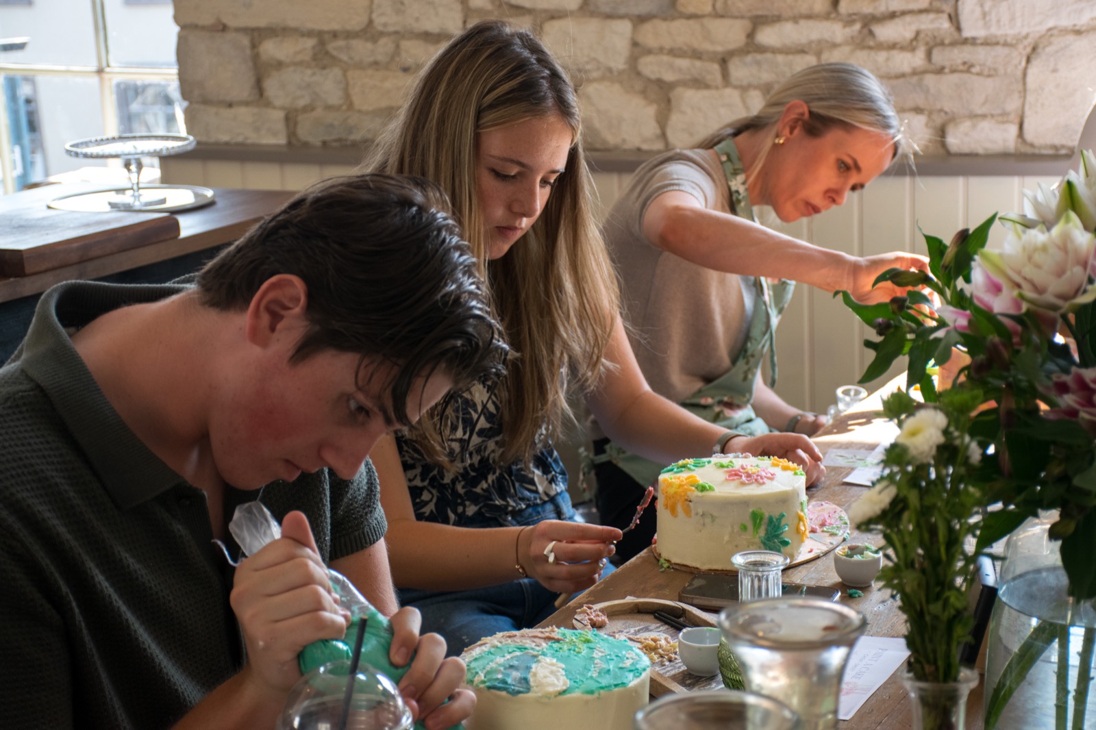 Guests sharing a lively cake-painting table