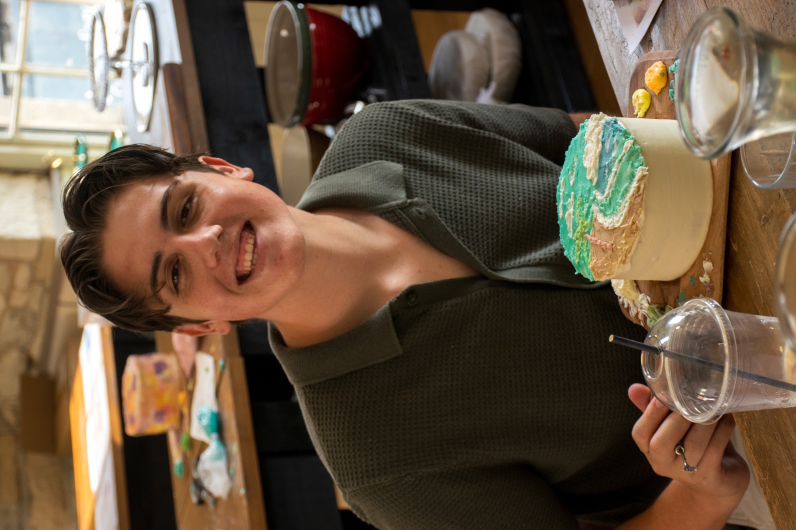 A smiling guest beside his painted cake