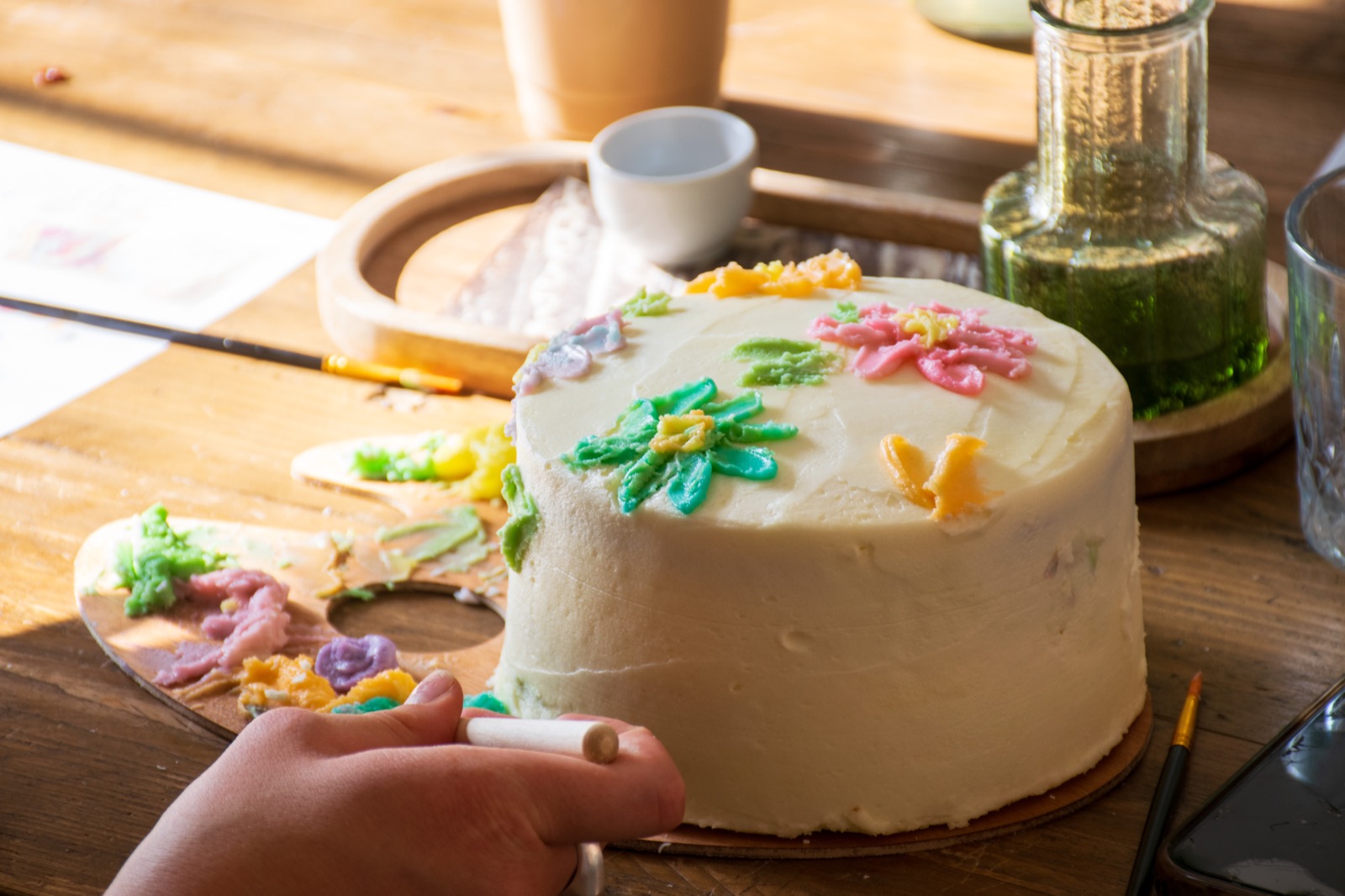 A floral design painted across the top of a celebration cake