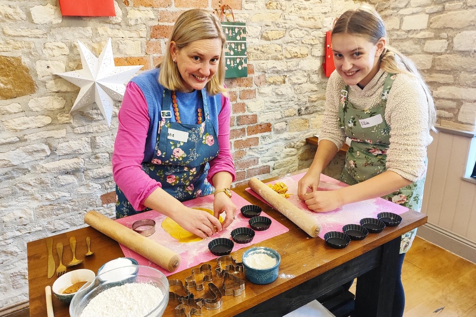 An adult and young guest shaping festive pastry together