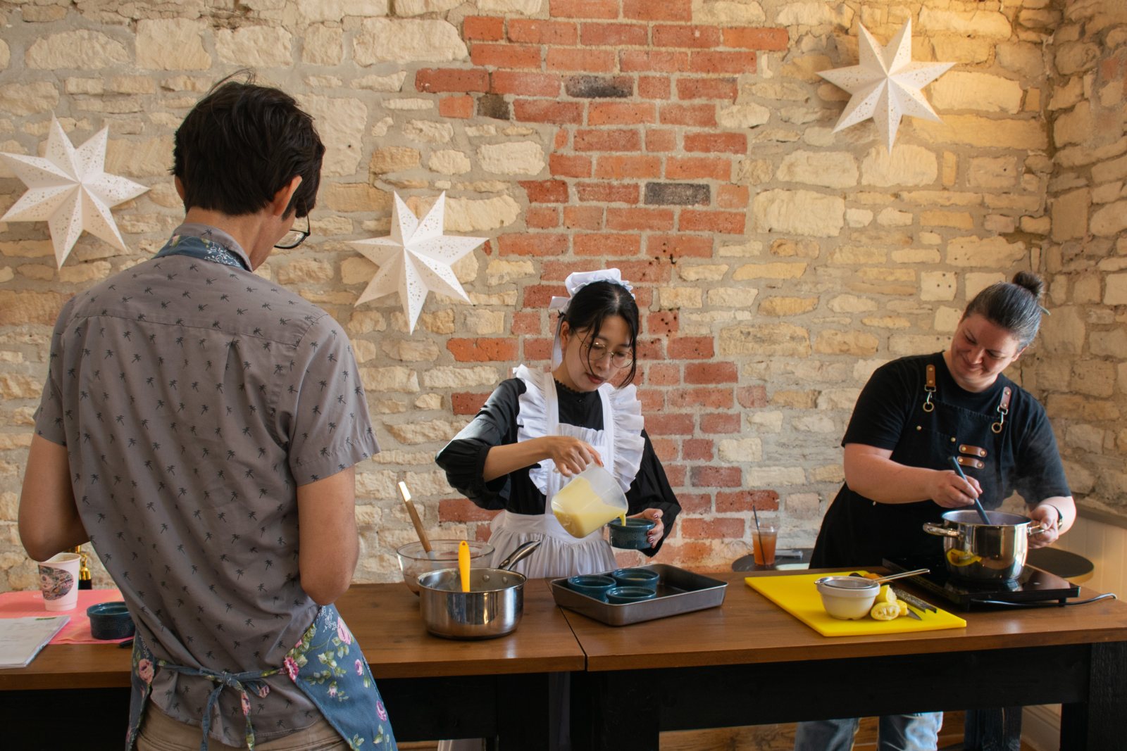 Guests icing festive biscuits around the workshop tables